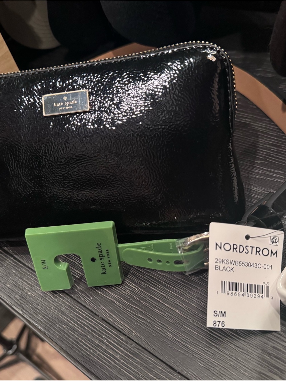 kate spade glossy black patent wristlet with gold plaque